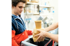 Image Man receiving takeaway food packaging for delivery.